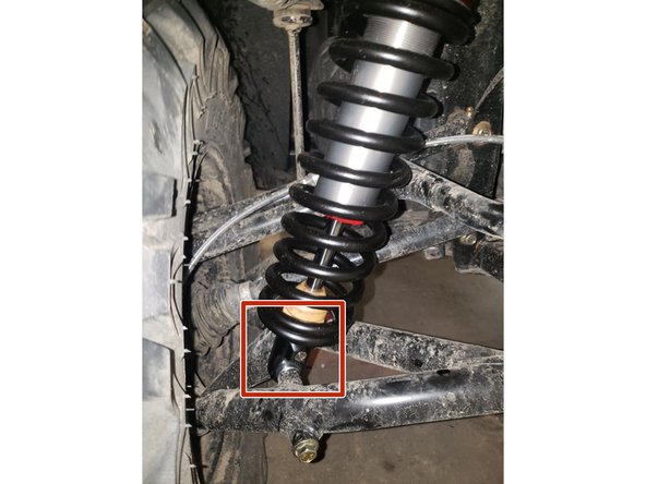 On Stage 2, Stage 4, and Stage 5 models the rebound adjuster located on lower eyelet of the shocks should be oriented towards the rear of the vehicle, as shown. (Shown by the red square ). If needed, you can turn the lower eyelet to orient properly.