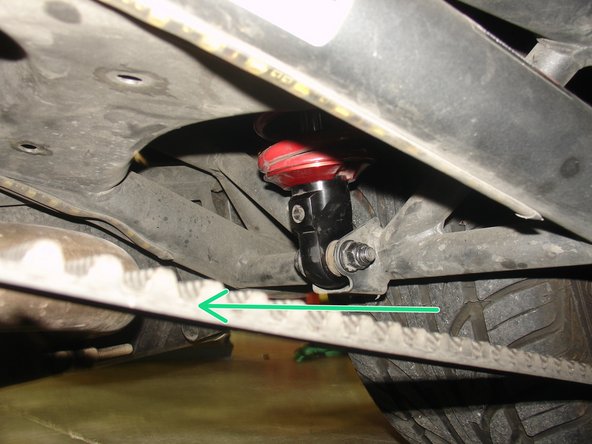 On Stage 4, and Stage 5 models the rebound adjuster located on lower eyelet of the shocks should be oriented towards the front of the vehicle, as shown by green Arrow. If needed, you can turn the lower eyelet to orient properly.