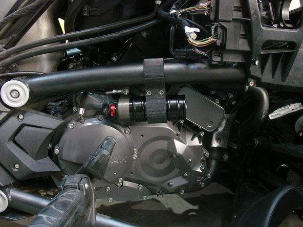 Pass the reservoir behind the frame and attach it with the supplied bracket (see next step).