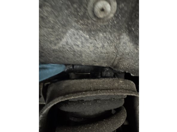 Remove the 3 nuts at the top of the shock.