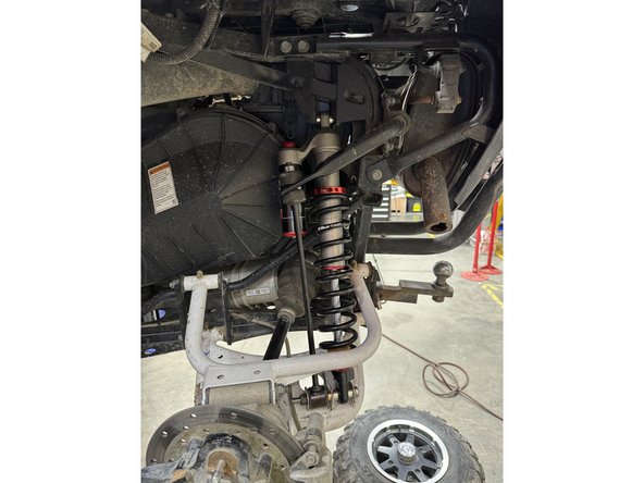 Install the rear shock with the reservoir facing the front of the side by side.