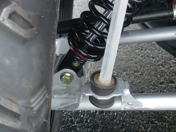 On Stage 2, Stage 4, and Stage 5 models the rebound adjuster located on lower eyelet of the shocks should be oriented towards the rear of the vehicle, as shown. (Left side shown ). If needed, you can turn the lower eyelet to orient properly.