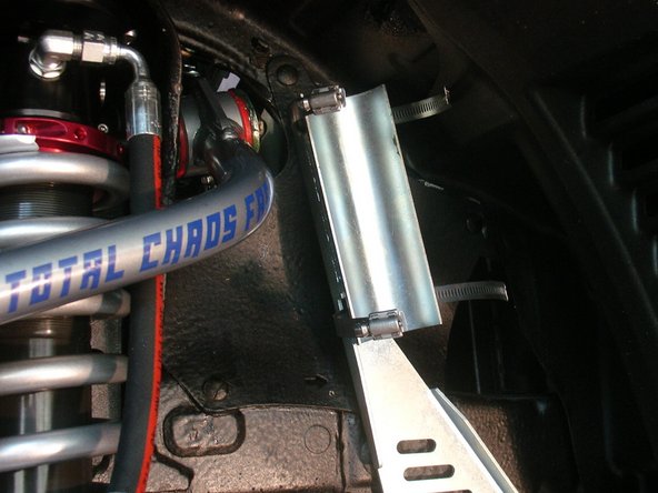 With the longer supplied bolts, and using the counter bore holes, fix the reservoir bracket in the sway bar mounting holes (right side shown).