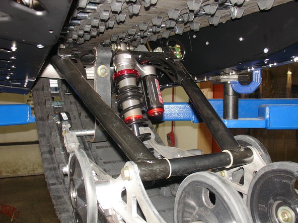 Install the Elka center shock with piggyback reservoir at the top and pointing towards the right side of the snowmobile as show on the photo.