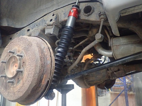 Place Elka shock head up as shown, then slide lower eyelet on oem lower shaft.