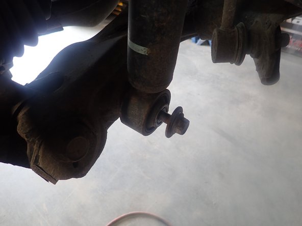 Remove upper and lower bolts and keep them to install Elka shocks.