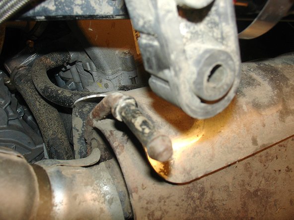 Detach the muffler from its 2 rubber attachments to facilitate the routing of the hose.