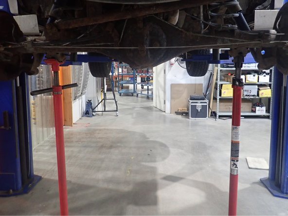 Using an underhoist stand or a jack, support rear axle before  removing oem shocks. Remove oem shocks and all oem hardware.