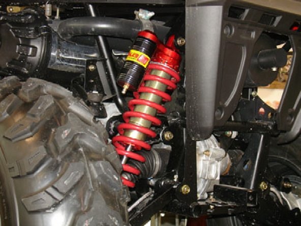 Driver side: Install the Elka shock absorbers bolting the top mount first with the piggyback reservoirs towards the outside of the vehicule.