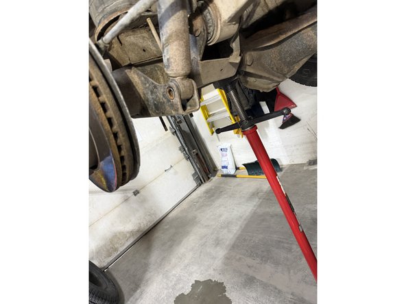 Remove upper nuts and lower bolts, then remove OEM shocks.