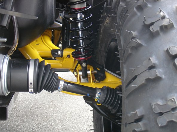 On Stage 2, Stage 4, and Stage 5 models the rebound adjuster located on lower eyelet of the shocks should be oriented towards the rear of the vehicle, as shown. (Right side shown ). If needed, you can turn the lower eyelet to orient properly.