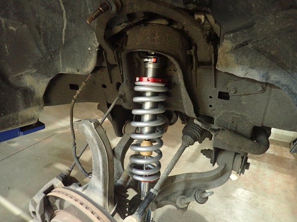 Install new Elka shocks in place with the arrow on top plates facing outside, then  torque 3 upper bolts at 35 Ft-Lb, and lower bolt at 80 Ft-Lb.