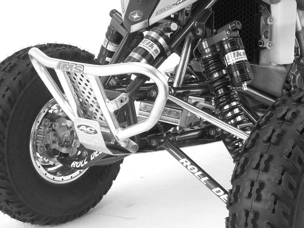 The rear reservoir must be attached to the front of the frame on the left side of the quad, right underneath the fender. The compression knobs must face towards the side of the quad.