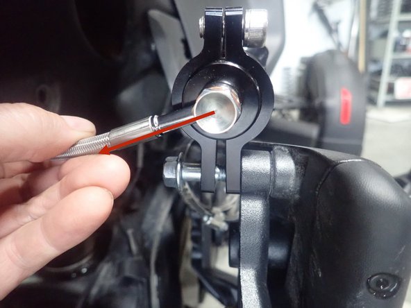 On the right side of vehicle, remove upper bolt that hold exhaust bracket.