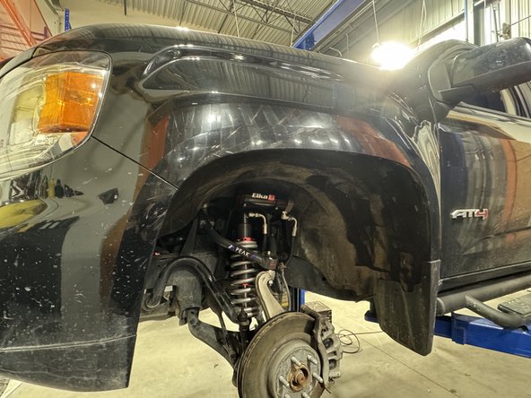 Install the bracket of the reservoir on top of the shock mount.