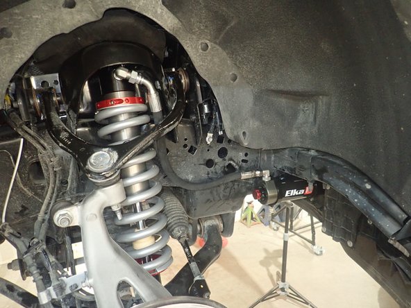 Install the Elka shocks using provided lower bolts and the provided upper bolts. Hoses must face the front of vehicle as shown (right side shown).
