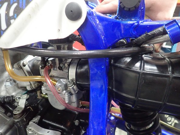 Install shock with the hose fitting facing rear of atv.