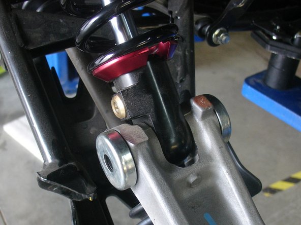 On Stage 2, Stage 4, and Stage 5 models the rebound adjuster located on lower eyelet of the shocks should be oriented towards the rear of the vehicle, as shown. (Left side shown ). If needed, you can turn the lower eyelet to orient properly.