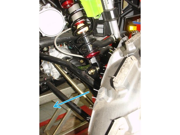 On Stage 2, Stage 4 and Stage 5 models, the lower shock eyelets should be installed with the rebound adjuster oriented towards the rear of the vehicle as shown by the blue arrow on the photo (right side shown). If needed, you can turn the lower eyelet to orient properly. This will facilitate access to the adjuster.