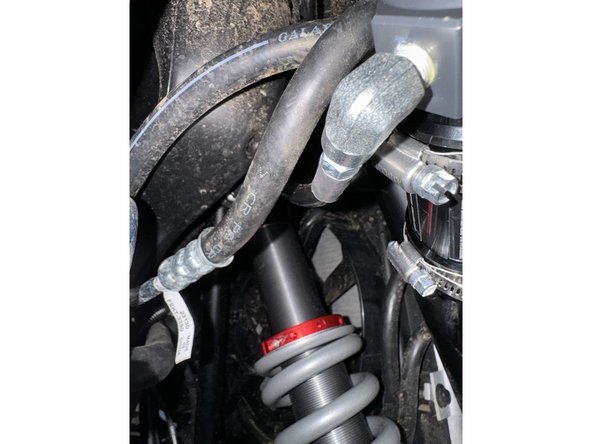 Route the hose properly and install the shock reservoir to the frame as shown. Use the reservoir holder that came with the shock.