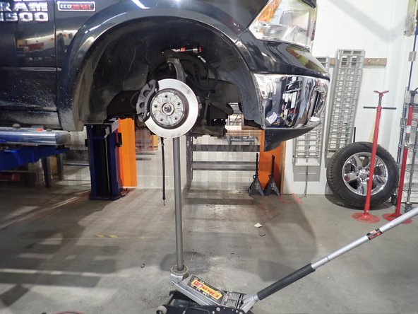 Reassemble knuckles and upper control arms. You may need to jack lower arm to help installing ball joint nut.