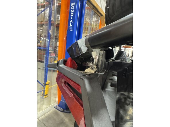 Lift the side panel as shown to make room for the reservoir.