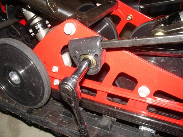 Remove both rear torsion springs holders to remove tension on rear shock.                                                                        THOSES SPRINGS ARE UNDER TENSION, BE CAREFUL WHEN REMOVING THEM 