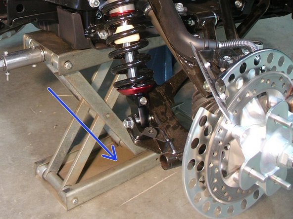 On Stage 2, Stage 4, and Stage 5 models the rebound adjuster located on lower eyelet of the shocks should be oriented towards the outside of the vehicle, as shown by the blue arrow. ( right side shown ). If needed, you can turn the lower eyelet to orient properly.