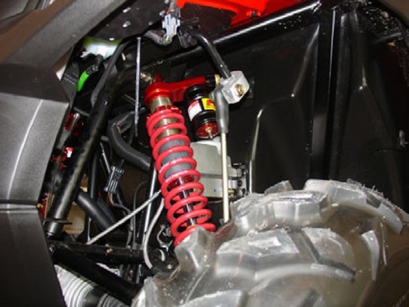 Driver side: Install the Elka shock absorbers bolting the top mount first with the piggyback reservoirs towards the rear with the compression adjustments facing towards the outside of the vehicule.