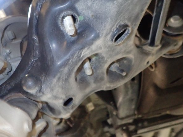 Remove the nuts from the upper and lower shock mounts.