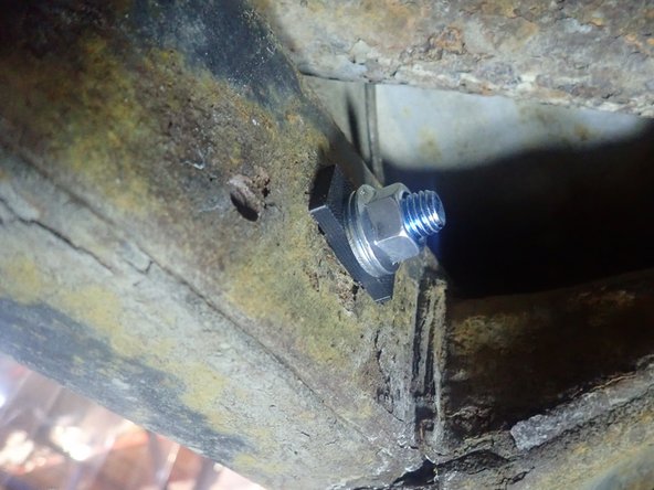 Use second aluminium square spacer inside of frame, then install supplied washer and nut. Apply threads locker, then torque nut at 40 Ft-Lb.