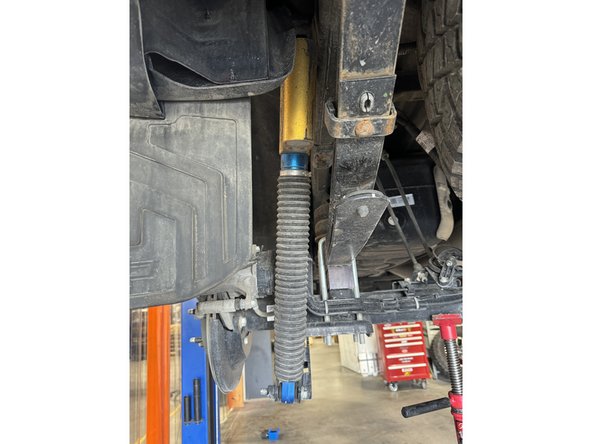 Remove upper and lower bolts from OEM shocks. Keep OEM bolts to install Elka shocks.