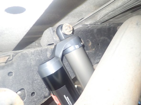 ON REAR RIGHT SIDE: Install the rear right shock with the reservoir facing the front of vehicle as shown.