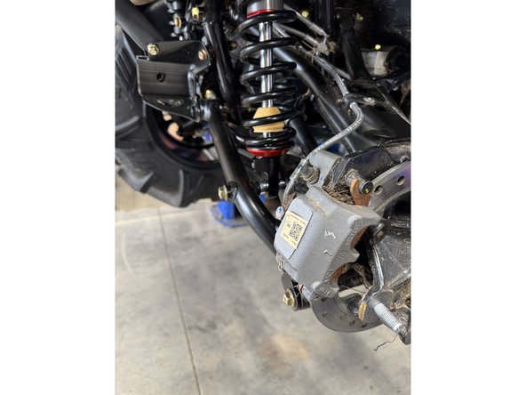 On Stage 2, Stage 4, and Stage 5 models the rebound adjuster located on lower eyelet of the shocks should be oriented towards the rear of the vehicle, as shown. (Right side shown ). If needed, you can turn the lower eyelet to orient properly.