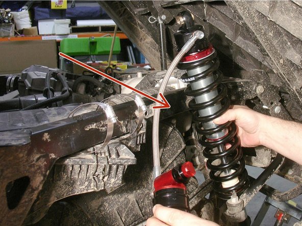 Tilt the bed of the vehicle to get access to the rear shocks.