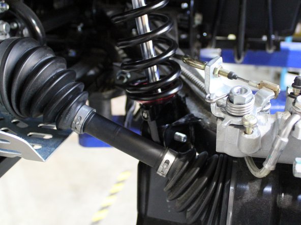 On Stage 2, Stage 4, and Stage 5 models the rebound adjuster located on lower eyelet of the shocks should be oriented towards the rear of the vehicle, as shown. (Right side shown ). If needed, you can turn the lower eyelet to orient properly.