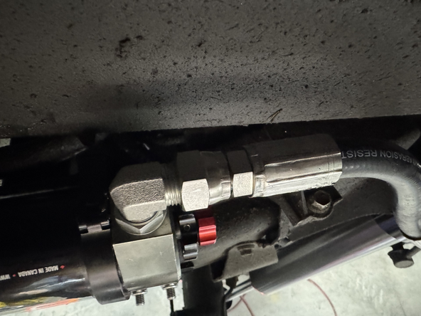 Use the supplied hardware to hold the bracket with the hole in the  frame reveal by removing the plastic cap.