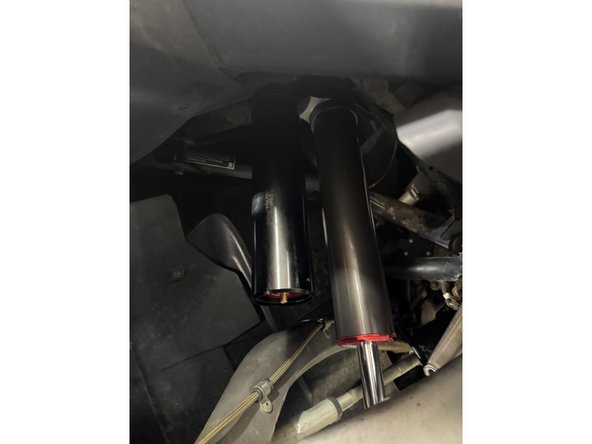 Install the piggyback shock with the reservoir upward and facing outside the vehicle.
