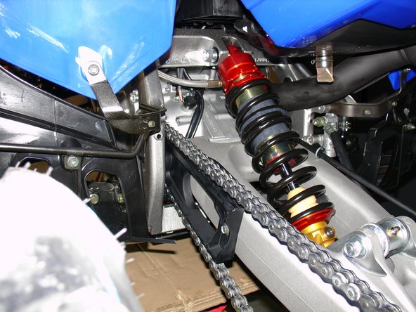 Install shock with the hose facing front of atv and pointing to left side.