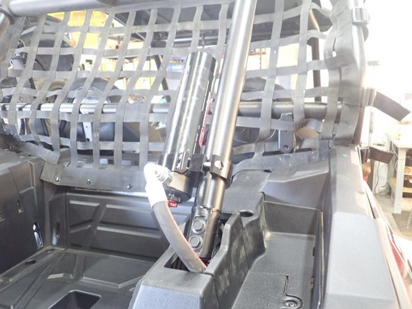 Attach the reservoir to the rear of the roll cage as shown using the provided mounting bracket.