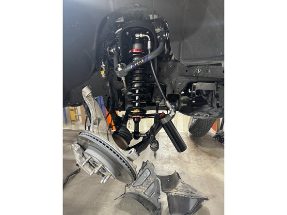 Be sure the lower mount's flats are facing lower arm as shown by blue circle. You can turn the lower pin if needed.