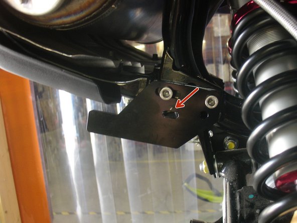 Remove the bolts used to secure the lower part of the rear luggage rack, and secure the supplied bracket as shown with the longer bolt provided. (right side shown)