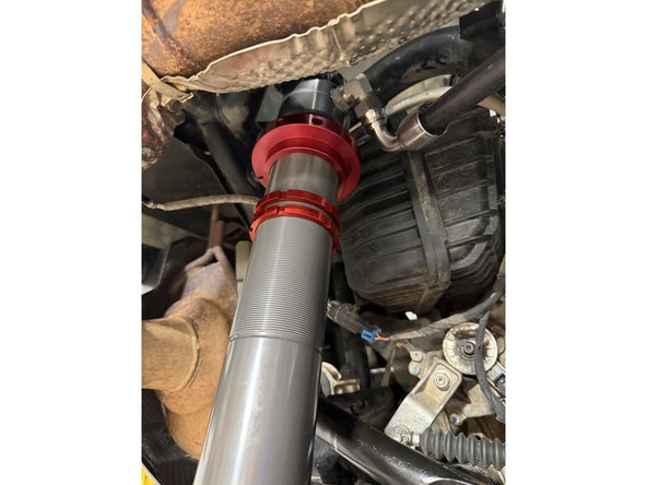 Note: The hose configurations differ between the left and right sides. Refer to the images to ensure the shocks are installed on the correct side.