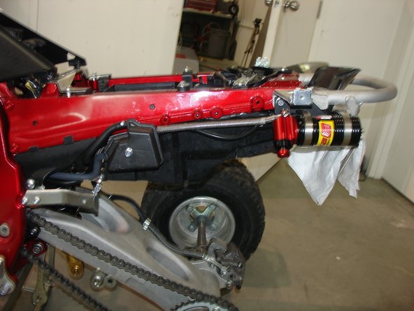 Pass the rear hose near the sub frame and install overflow oil tank.