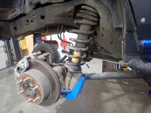 Lift the vehicle off the ground, then remove the rear wheels