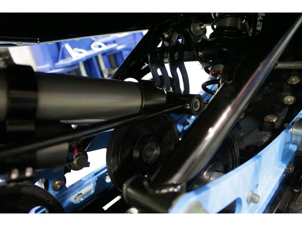 Install the Elka rear shock with the reservoir at the bottom and oriented towards the rear of the snowmobile as shown on the photo.