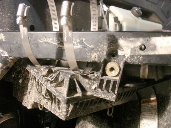 Remove the bolt holding the air box to allow enough clearance to slide in the provided reservoir collars.