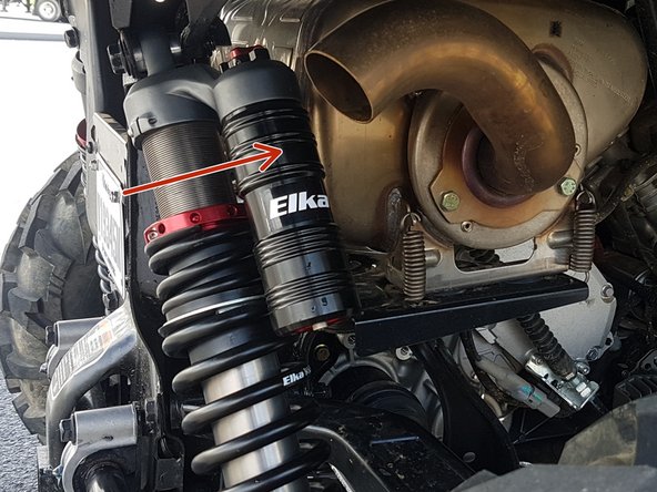 Install the left and right new Elka rear shock with the piggyback reservoir at the top and oriented towards the front of the vehicle as indicated by the red Arrow on the photo. On Stage 1 and Stage 2, the left and the right shock are the same. Just install them with the shraeder nitrogen valve at the top of vehicle.
