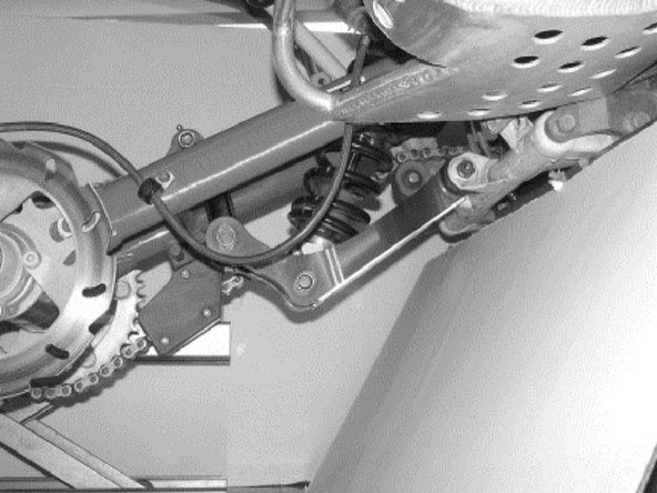 Attach the black part to the red part of the linkage.