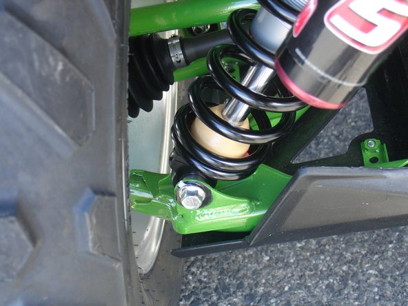 On Stage 2, Stage 4, and Stage 5 models the rebound adjuster located on lower eyelet of the shocks (red knob not shown on photo) should be oriented towards the outside of the vehicle, as shown. (Left side shown ). If needed, you can turn the lower eyelet to orient properly.